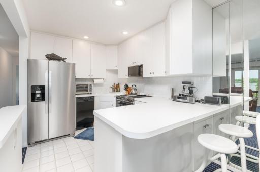 The clean white kitchen was updated with recessed LED lighting and stainless appliances.