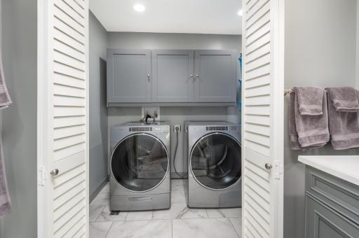 The laundry room has premium washer and dryer, cabinetry and the entire tile floor is a custom disaster pan with drain. Outstanding!