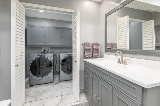 The large vanity has soft close doors and drawers and custom mirror.