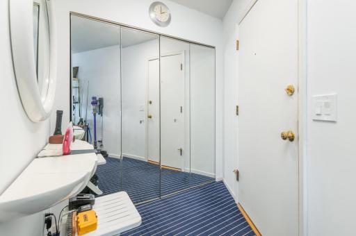 Large foyer for greeting guests. There is a deep closet with mirrored doors for coats and extra storage.