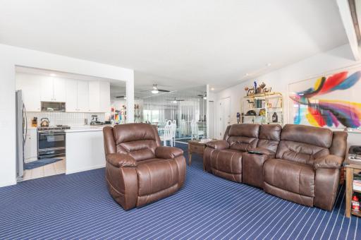 The condo has an all-white blank canvas to design as you wish. The blue carpeting has a clean nautical feel to it.