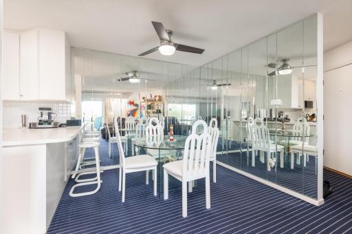 The dining area mirrored walls capture the excellent lake view from the new 8 foot triple pane sliding door.