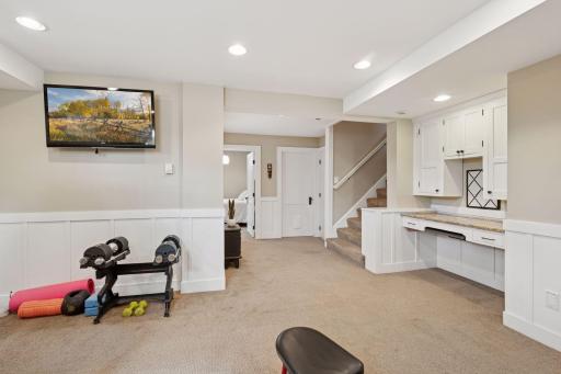 Lower level flex space which includes a 5th bedroom, bathroom, and laundry room