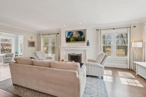 Spacious living room with 9ft ceilings and crown molding, including a fully functioning wood fireplace with new chimney liner in 2012