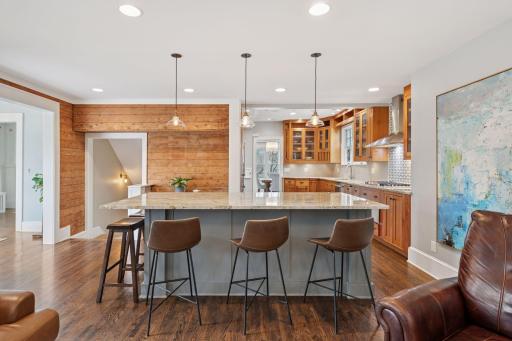 2015 addition begins at the wall of original shiplap and extends to include a kitchen expansion, family room with gas fireplace, and mudroom that conveniently attaches to a two-stall garage