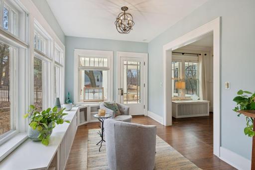 Original inviting sunroom that flows out to the screened-in porch