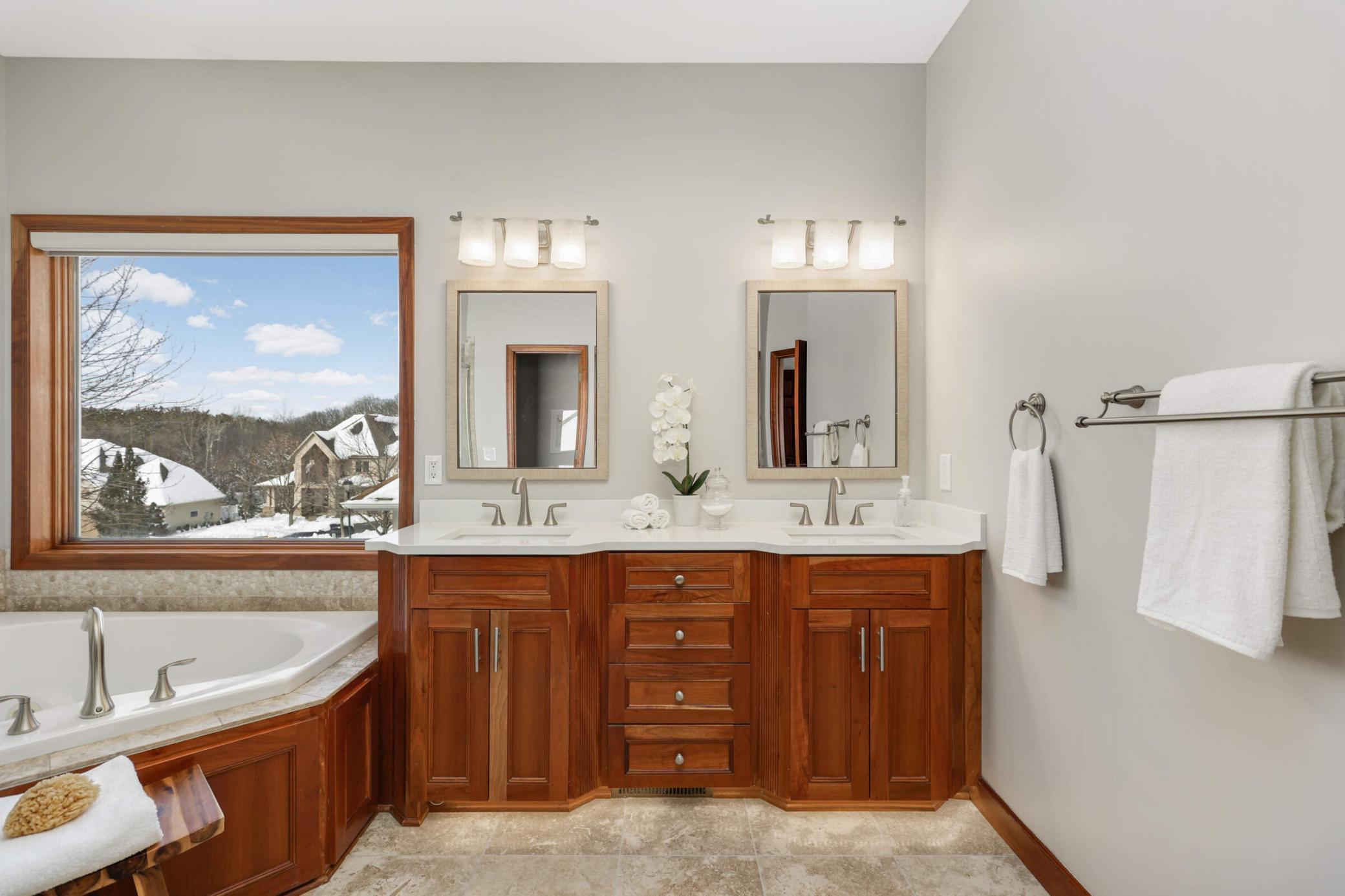Your bath is a luxurious haven, featuring elegant finishes, a spacious shower, and a soaking tub for ultimate relaxation