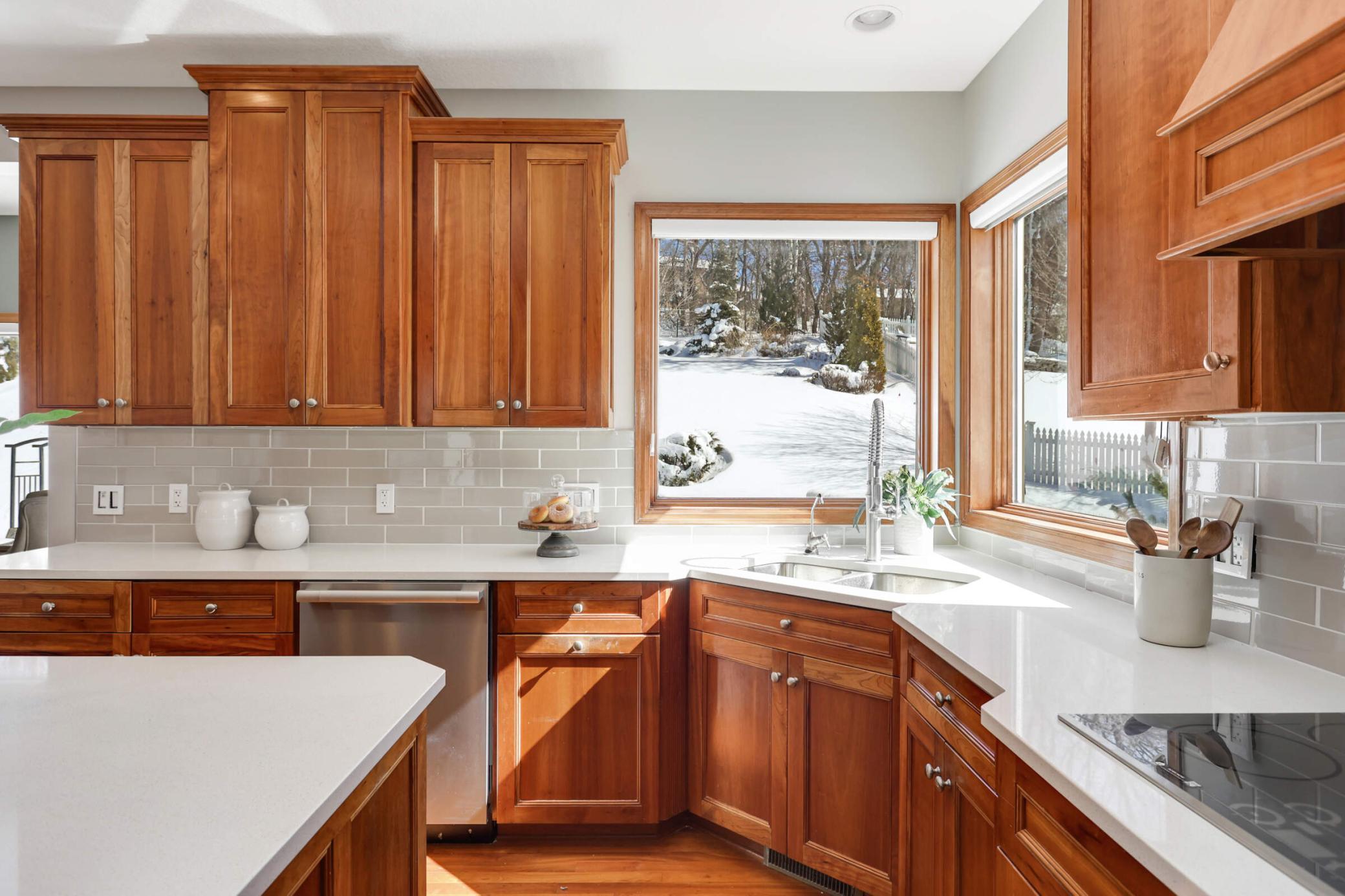 kitchen window brings in natural light and offers a view of the extensive backyard