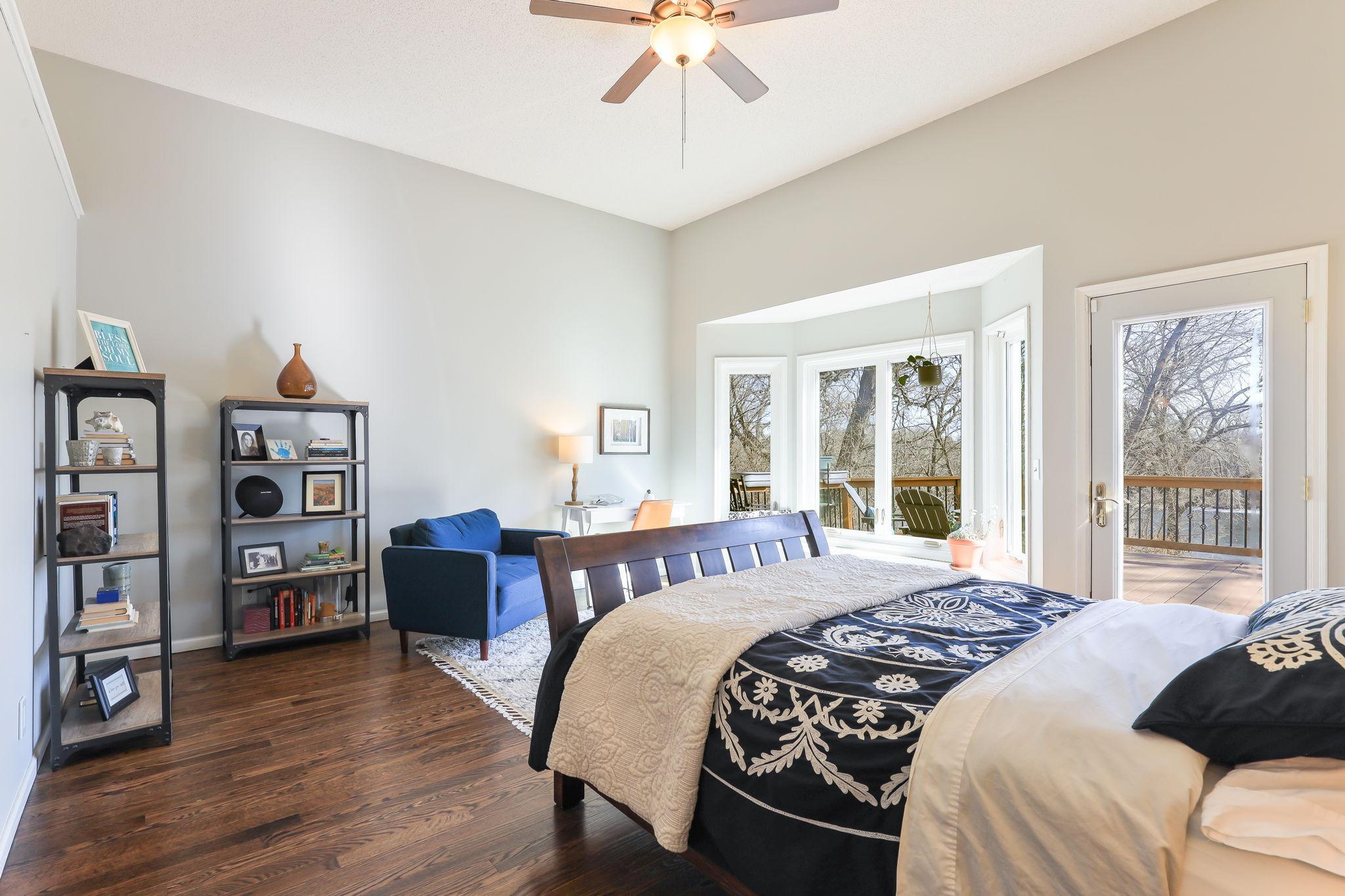 The primary bedroom has direct access to the backyard deck and views of the Mississippi River.