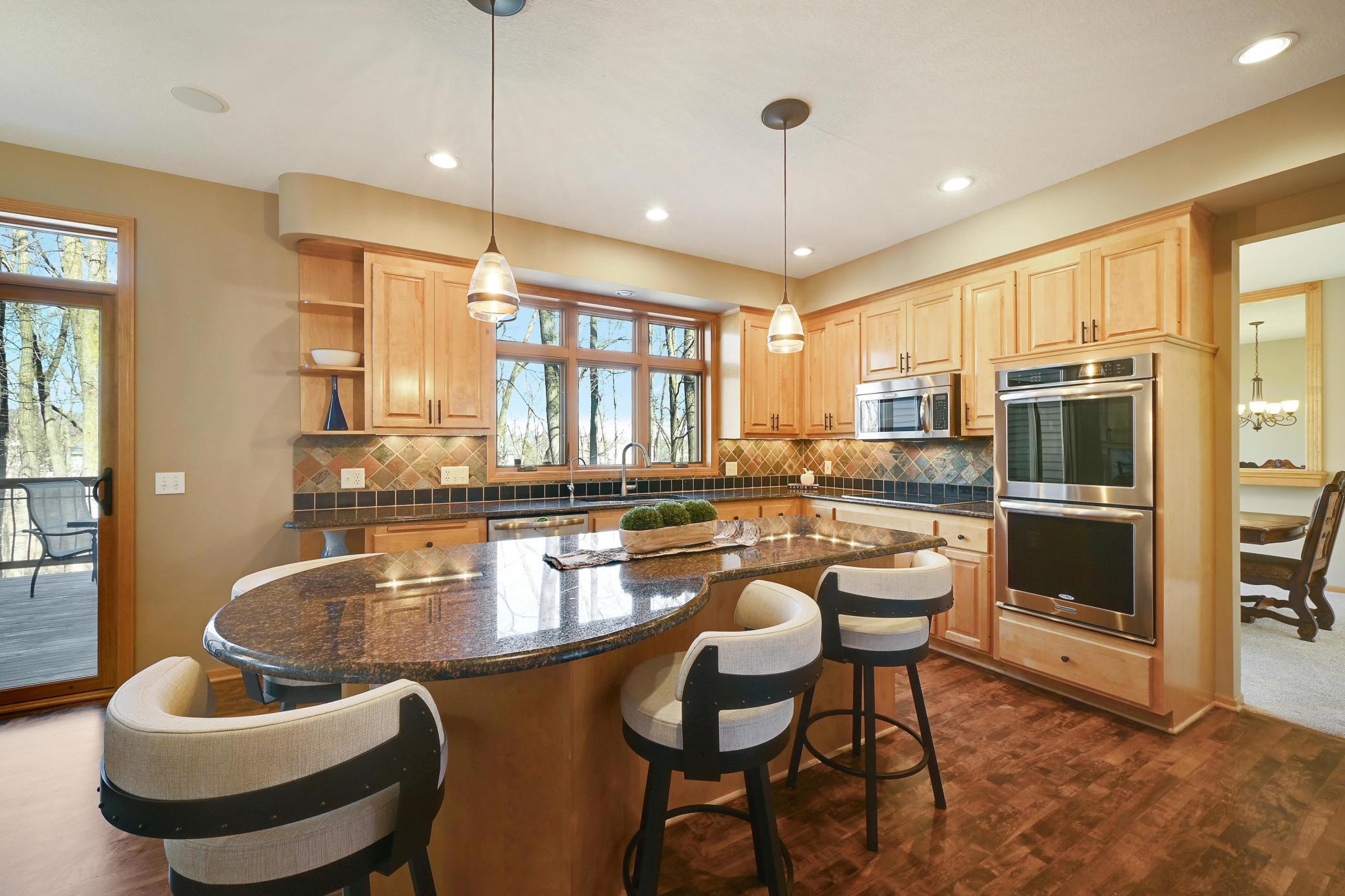 An informal dining area, bar stools and a formal dining - so much room to entertain.