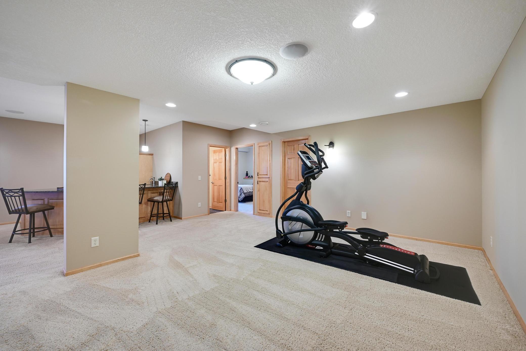 Move workout equipment into the room to the right and use this as a game room next to the bar!