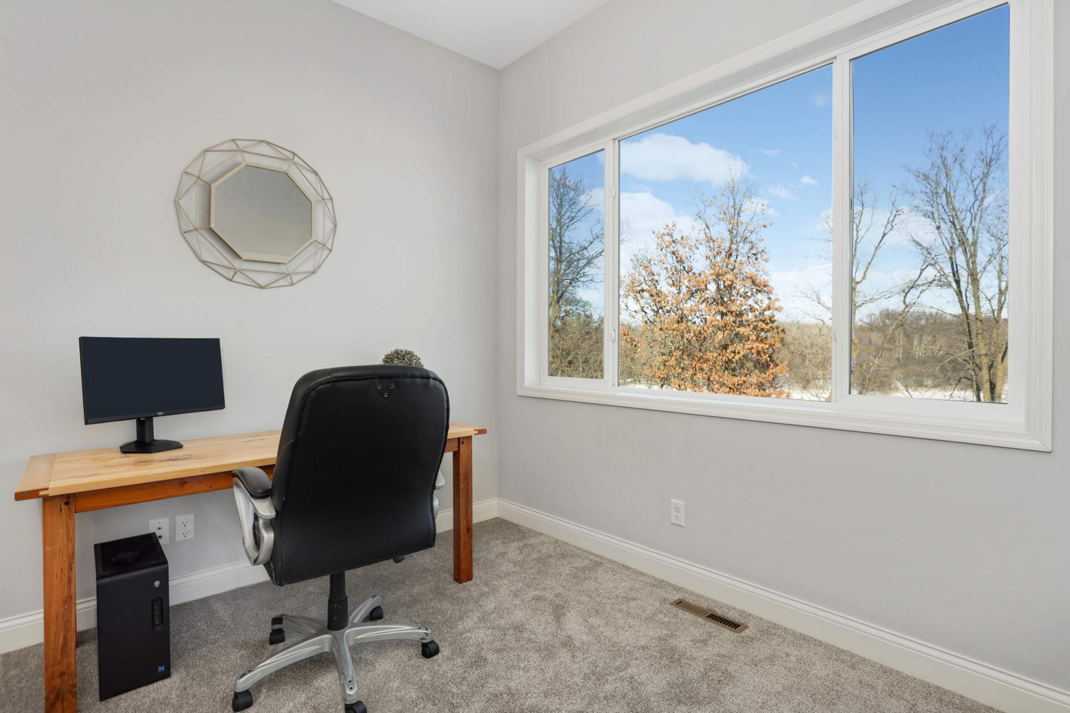 This main level bedroom is currently being used as an office. Enjoy stunning views while you work!