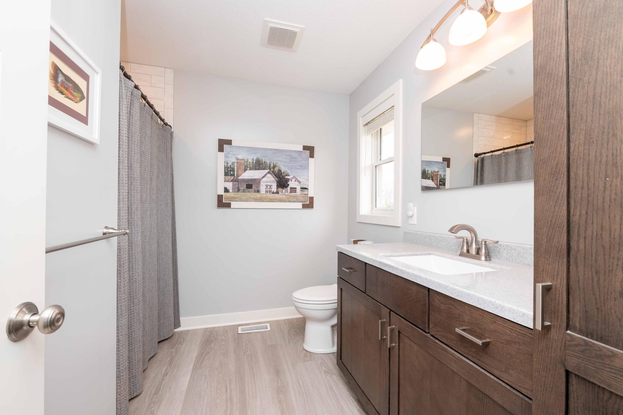 Full bathroom with easy care flooring. Keeps toes warmer than tile!