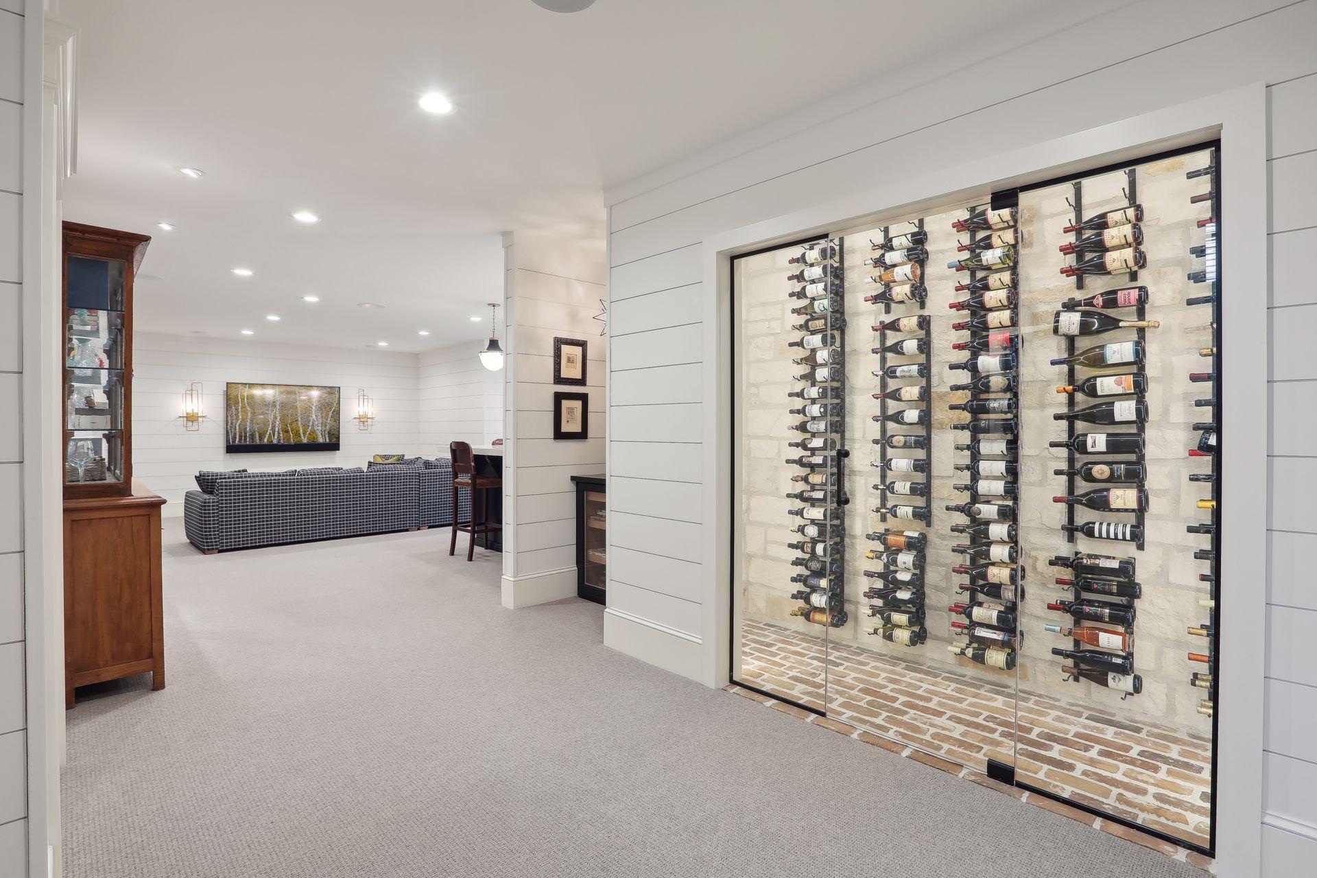 This is a piece of art! Custom wine cellar with "Old Chicago Brick" flooring, limestone wall accents, custom glass door and contemporary shelving.