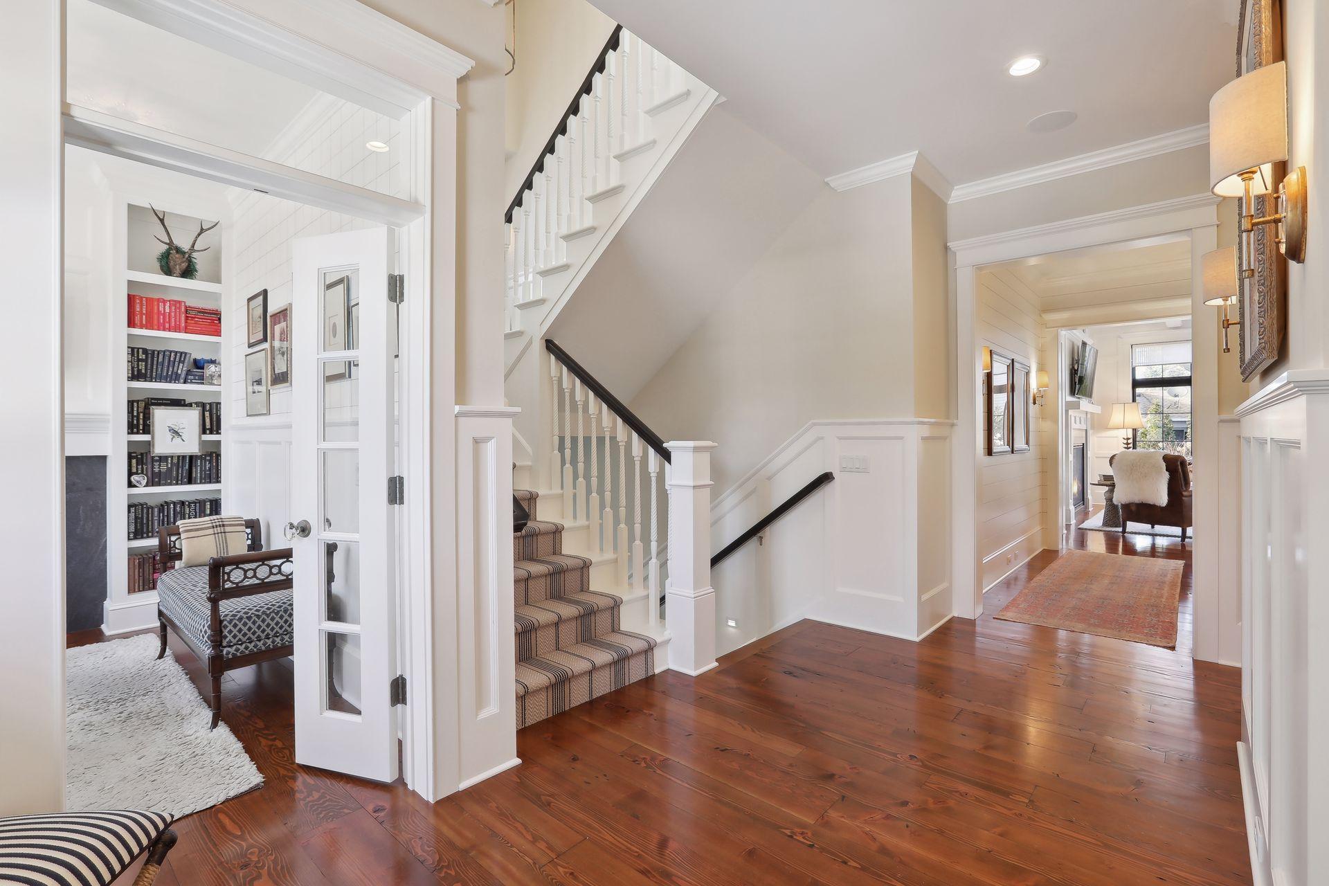 Open custom staircase with window seat, gorgeous runner and lighting.