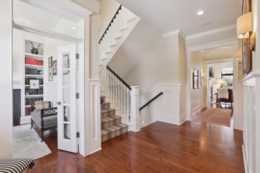 Open custom staircase with window seat, gorgeous runner and lighting.