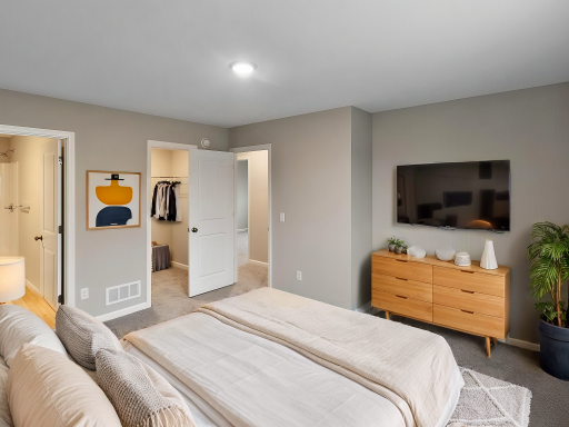 Primary Suite. Virtually Staged. Photo is taken of another home with similar plan and finishes.