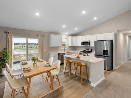 Dining and Kitchen. Virtually Staged. Photo is taken of another home with similar plan and finishes.