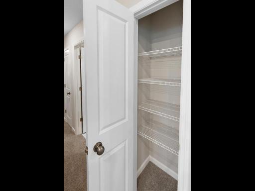 Pantry. Photo is taken of another home with similar plan and finishes.