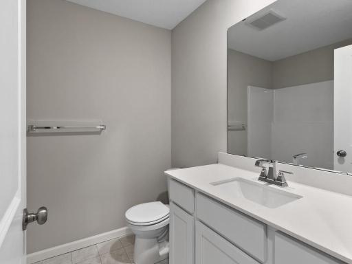 Hall Bathroom. Photo is taken of another home with similar plan and finishes.