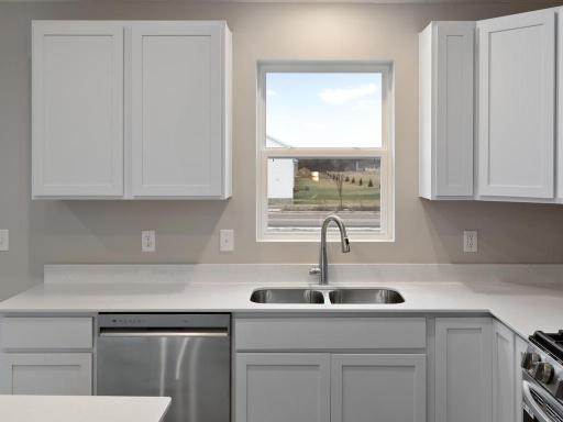 Kitchen. Photo is taken of another home with similar plan and finishes.