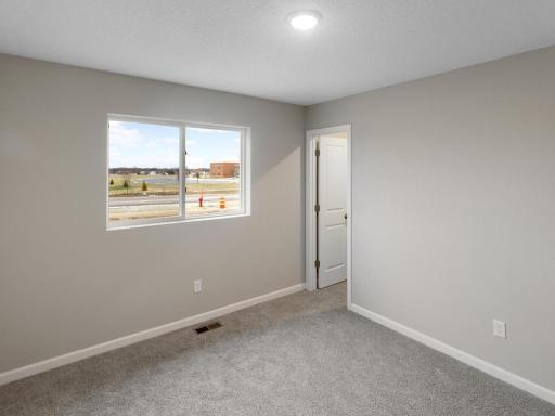 Bedroom #2 Walk In Closet. Photo is taken of another home with similar plan and finishes.