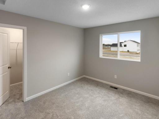 Bedroom #3 Walk In Closet. Photo is taken of another home with similar plan and finishes.