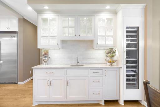 The dining room features a wet bar with built-in cabinetry and a wine fridge.