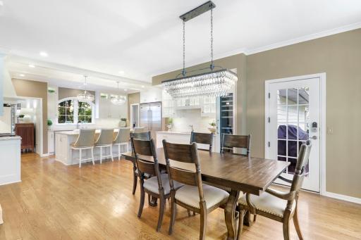 The dining room features a wet bar with built-in cabinetry and a wine fridge.