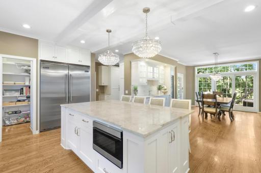 The newly remodeled, stunning, open concept, chefâs kitchen features Thermador and Viking appliances, in-cabinet lighting, a massive pantry with prep space and natural light, and a large center island with stool seating that opens to the dining room.