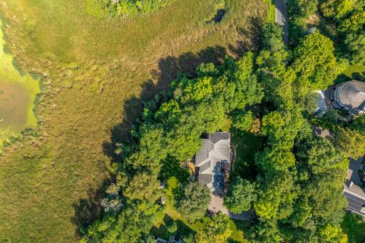 The home is set on a private, maturely wooded, acreage lot, on a quiet, charming cul-de-sac.