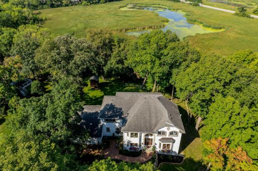 The home is set on a private, maturely wooded, acreage lot, on a quiet, charming cul-de-sac.
