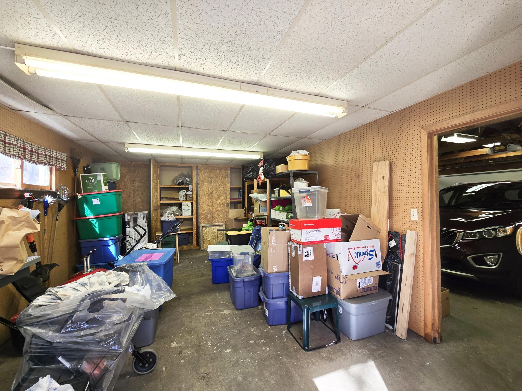 Large workshop in back of garage w/workbench (on left not pictured) & more closets