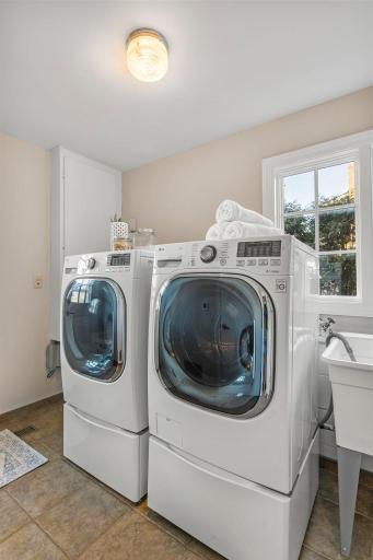 Descending from the main floor, youâll find the finished laundry room, complete a utility sink and heated flooring. A laundry chute adds convenience from the upstairs bedrooms and the space allows easy access to the backyard.
