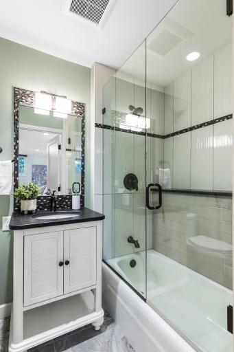 This guest room has a private full bathroom with heated tile flooring and a linen closet.