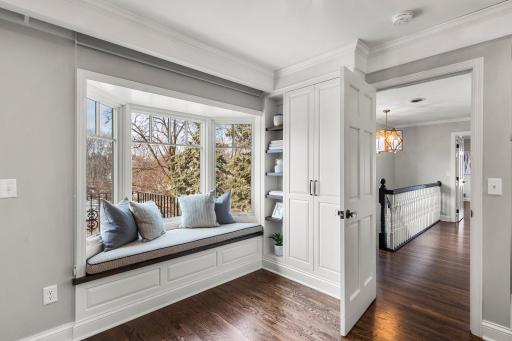 The primary bedroom boasts a built-in window seat, complete with a bookcase for your favorite reads and a hidden storage closet for added convenience and lastly, a private balcony overlooking the backyard.