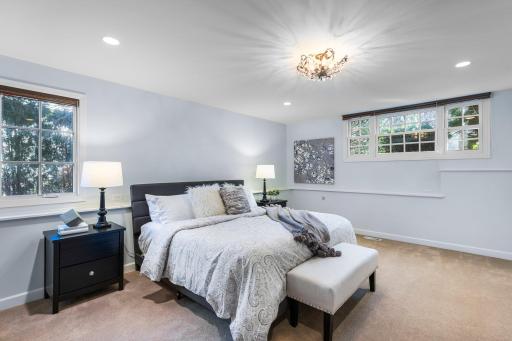 Across the hall, a spacious sixth bedroom serves as a perfect guest suite.