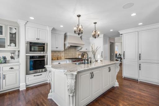 The thoughtfully designed kitchen is a culinary dream showcasing custom terracotta tile backsplash imported from Spain.