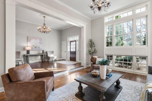 The floor-to-ceiling window in the formal living room floods the space with natural light, enhancing the roomâs open, airy feel.