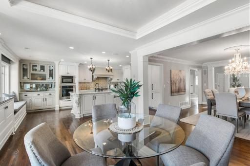This space seamlessly links to the mudroom, which offers storage lockers and bench seating with convenient access to the attached garage and deck.