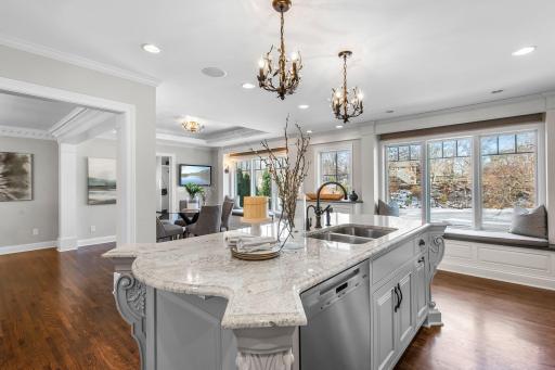 The kitchen features a cozy reading nook, perfect for relaxing with a book or enjoying quiet moments, nestled by large windows that invite natural light.