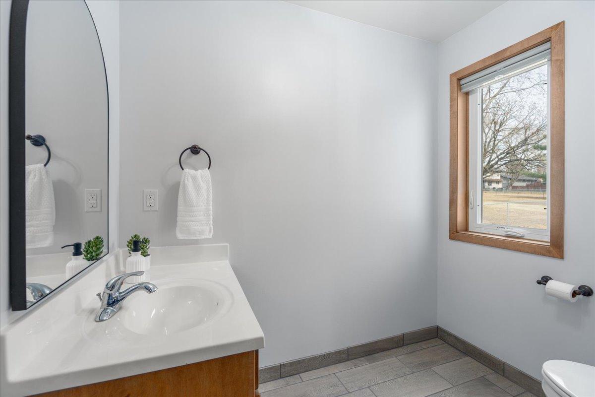 Main level half bath with tile flooring