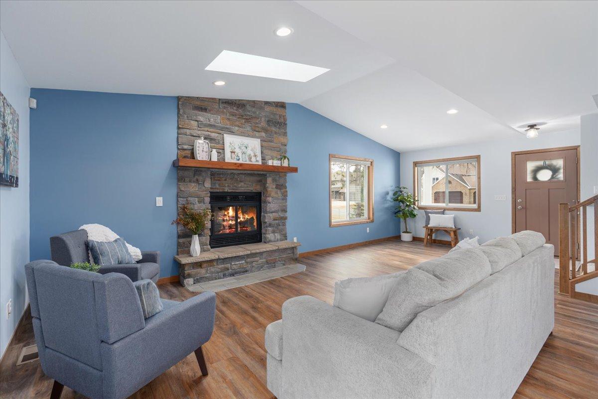 Wood burning fireplace with floor to ceiling stone surround