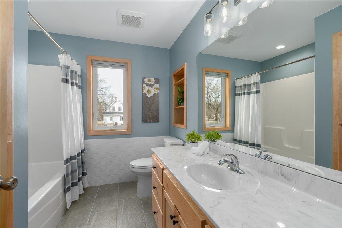 Full bathroom upstairs with tile flooring