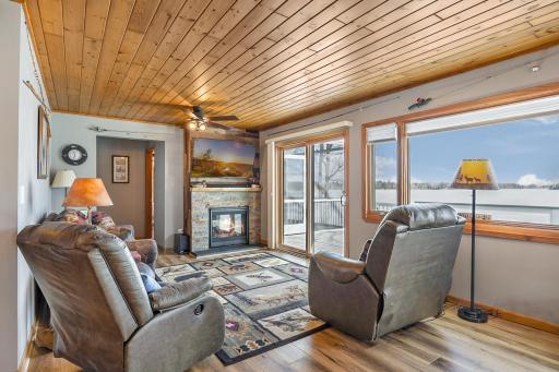 Living room with a patio door leading to the lakeside deck.