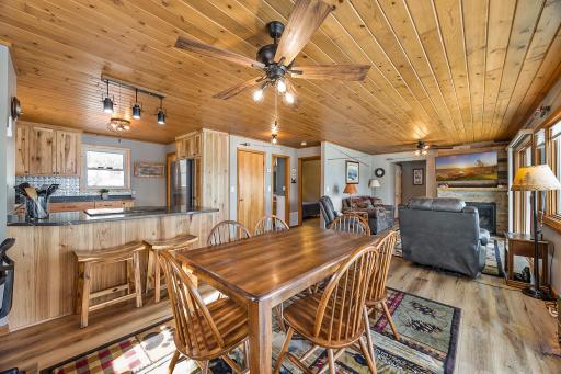 Open concept living with knotty pine ceilings.