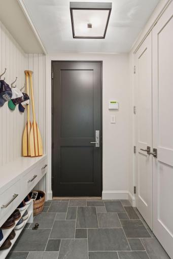 Enter in to your mudroom and simple hit "Welcome" on the Lutron lighting system to turn on the home lights of your choosing