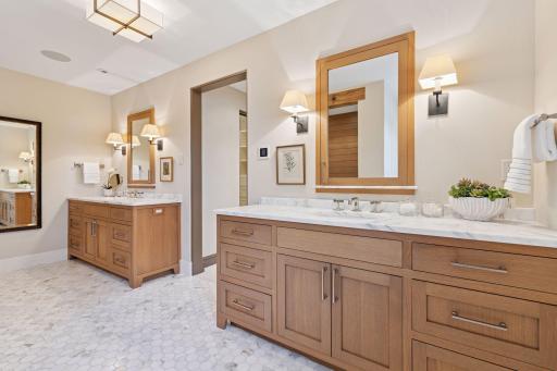 Primary bath features a freestanding soaking tub, oversized rain shower, and heated floors