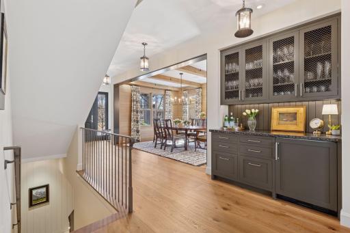Stylish dry bar with a built-in drink fridge provides the perfect spot for craft cocktails, wine storage, or your coffee station