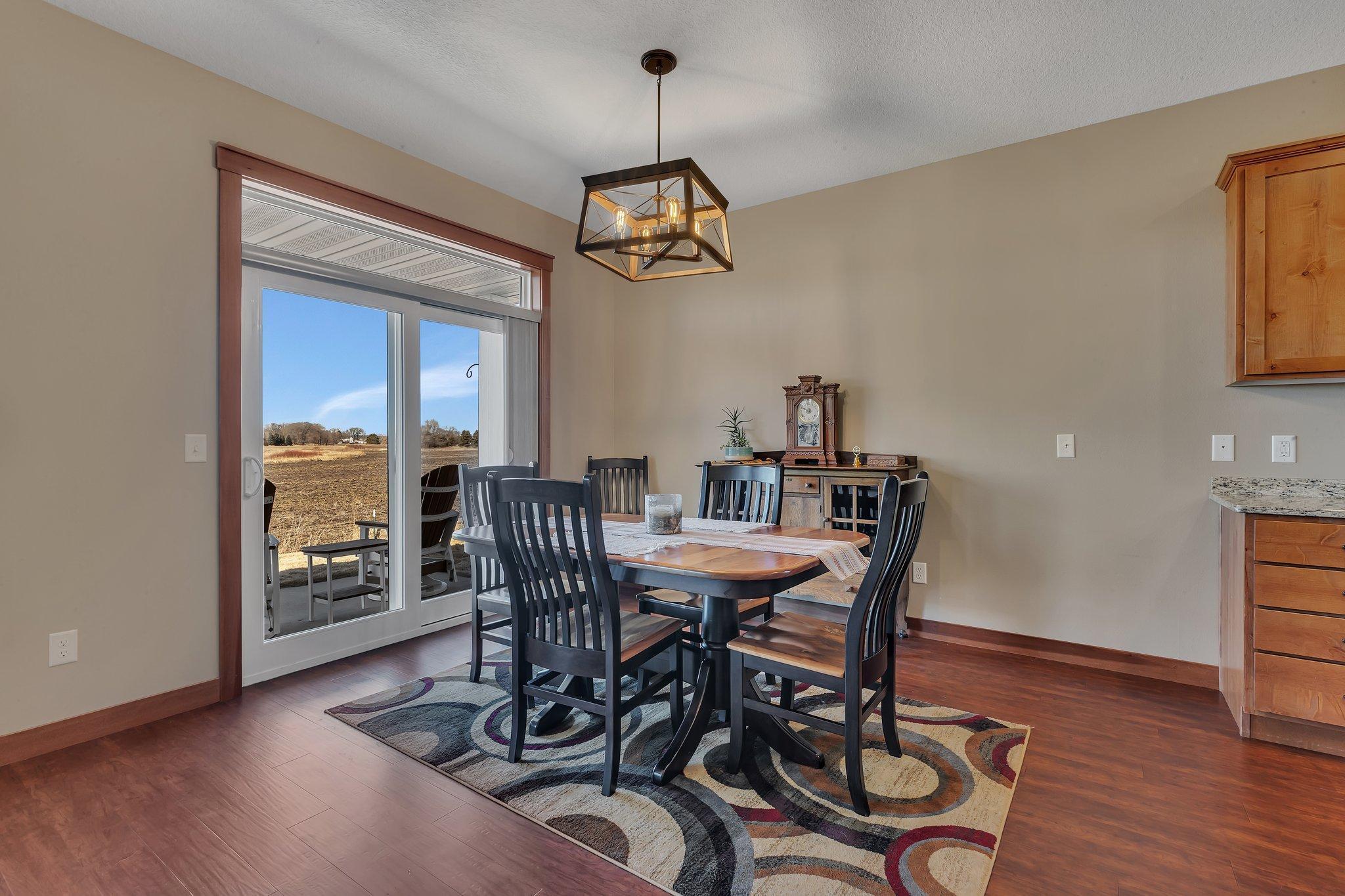 Well lit dining looks out to the back yard and patio.